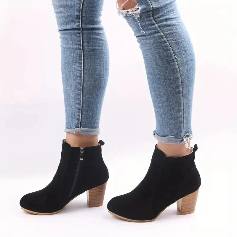 Elegant women's ankle boots with a comfortable block heel and easy side zip, great for autumn outfits.