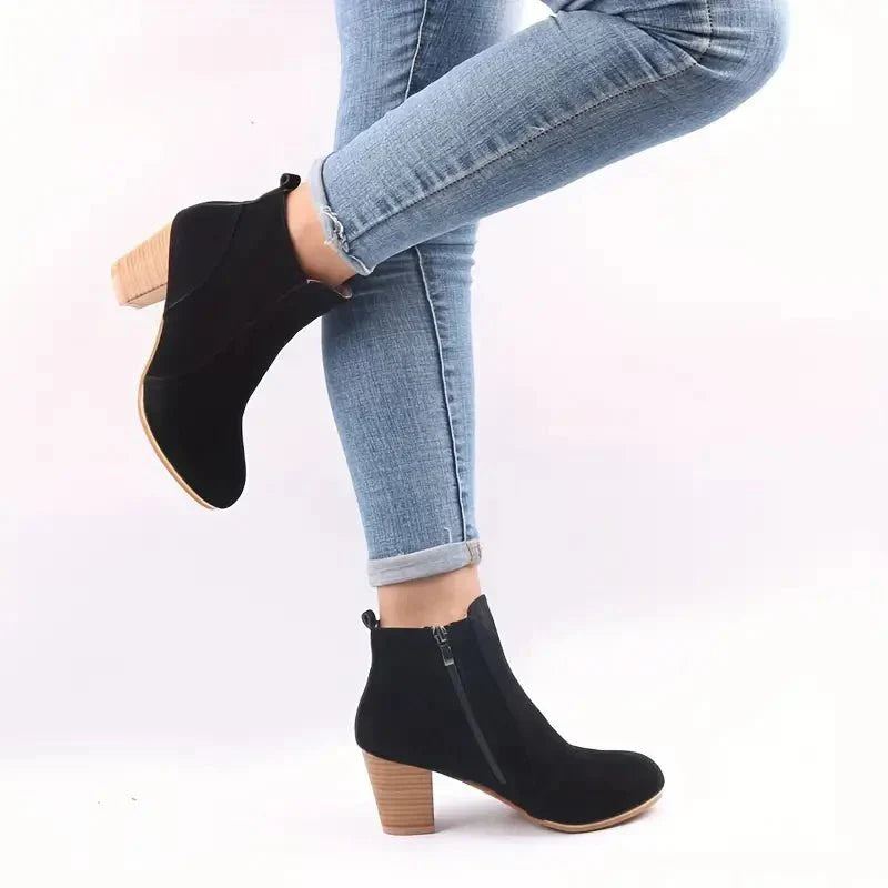 Women's fashion ankle boots with a block heel and side zip, suitable for various styles.