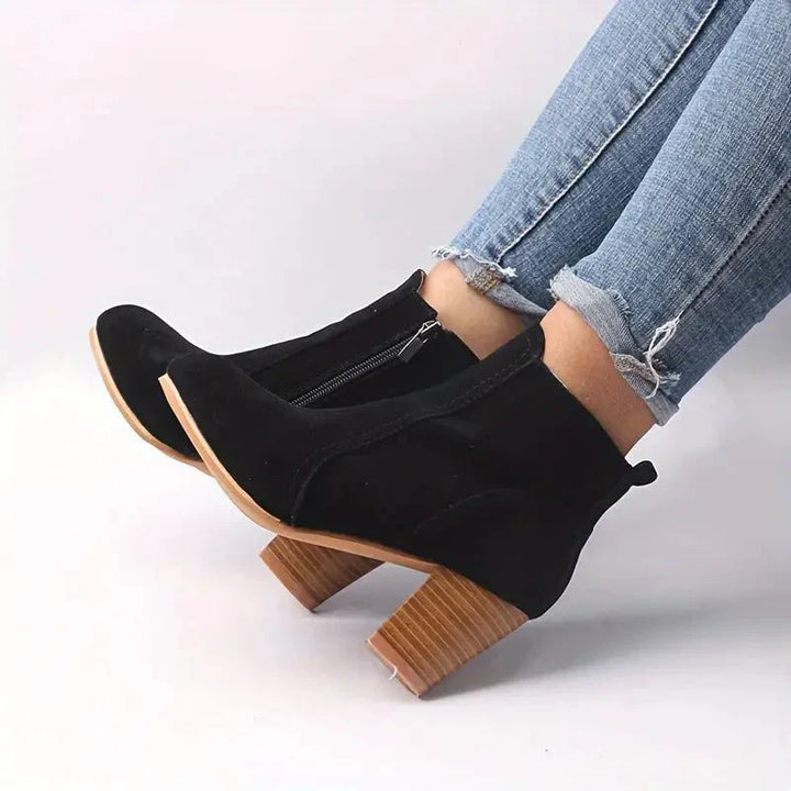 Dressy women's ankle boots featuring a stable block heel and functional side zip, perfect for elegant looks.