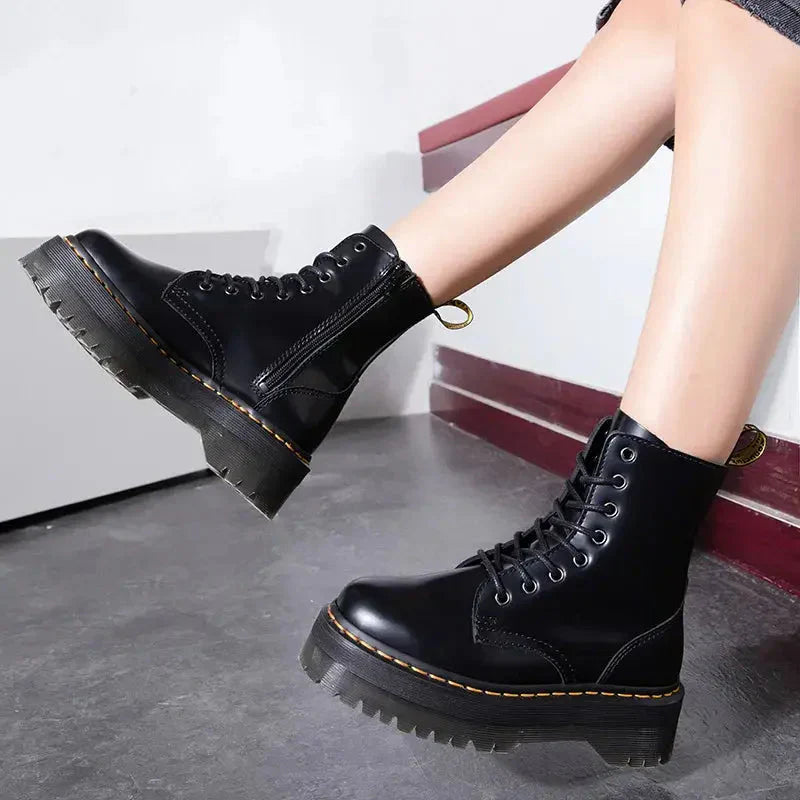 Trendy women's black platform ankle boots, featuring bold chunky soles & front lace-up closure for fall fashion.