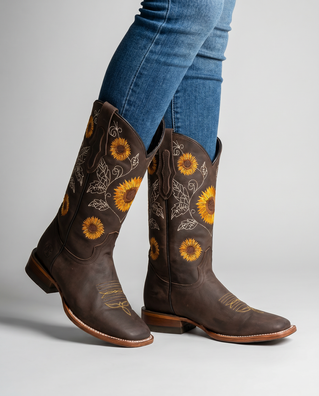 Elegant pair of women's embroidered cowgirl boots, tall design, low block heel, perfect for fall fashion.