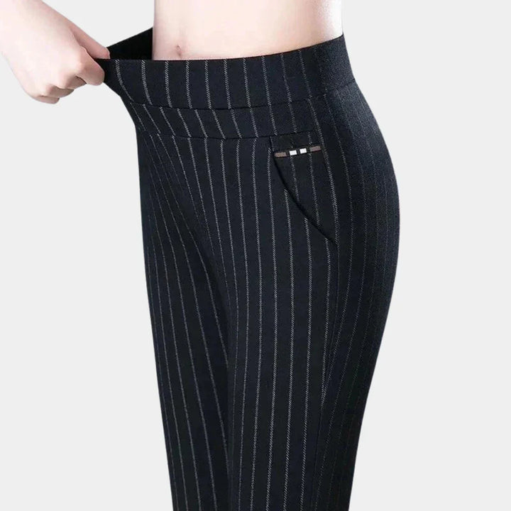 Stylish women's high-waisted black pants, featuring a comfortable stretch fabric and elastic waist for a flattering, fashionable fit.