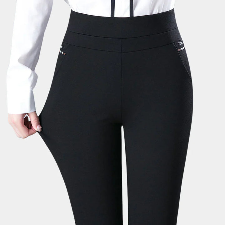 Versatile women's black stretch trousers, perfect for office or casual outfits. Comfortable high-waisted design with elastic waistband.