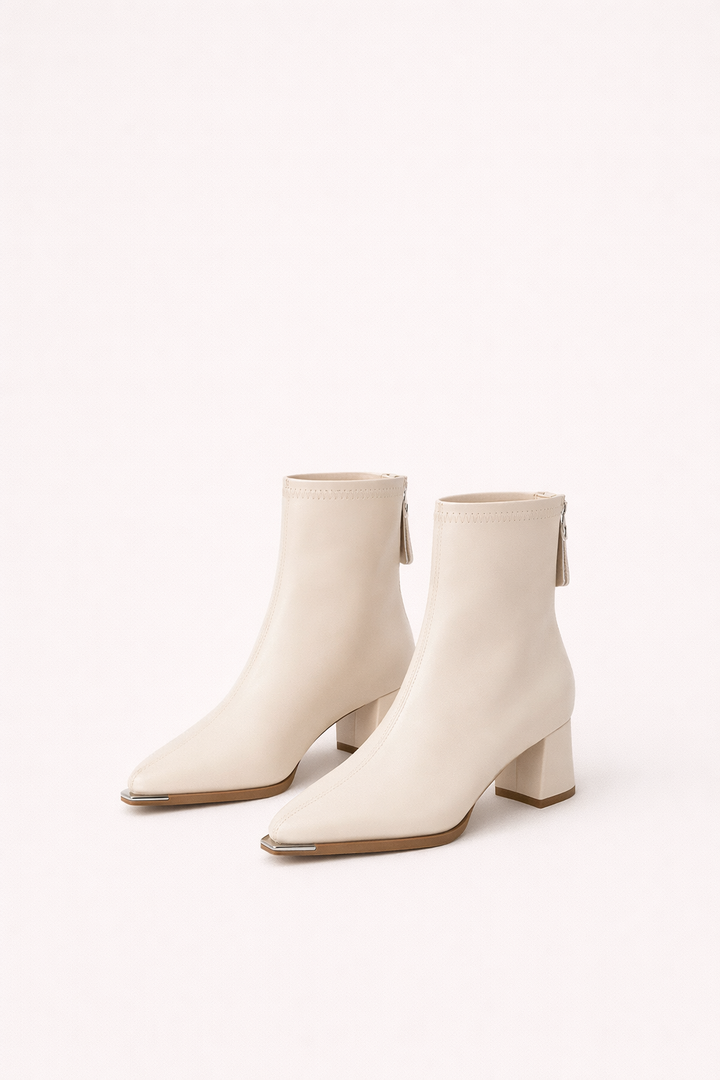 Women's black minimalist block heel ankle boots. Pointed toe, comfortable for office & everyday chic outfits.