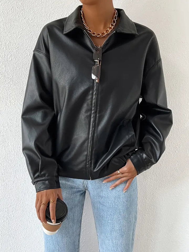 Women's sleek black moto jacket with prominent zip-up. A chic and edgy outerwear piece for cool weather.