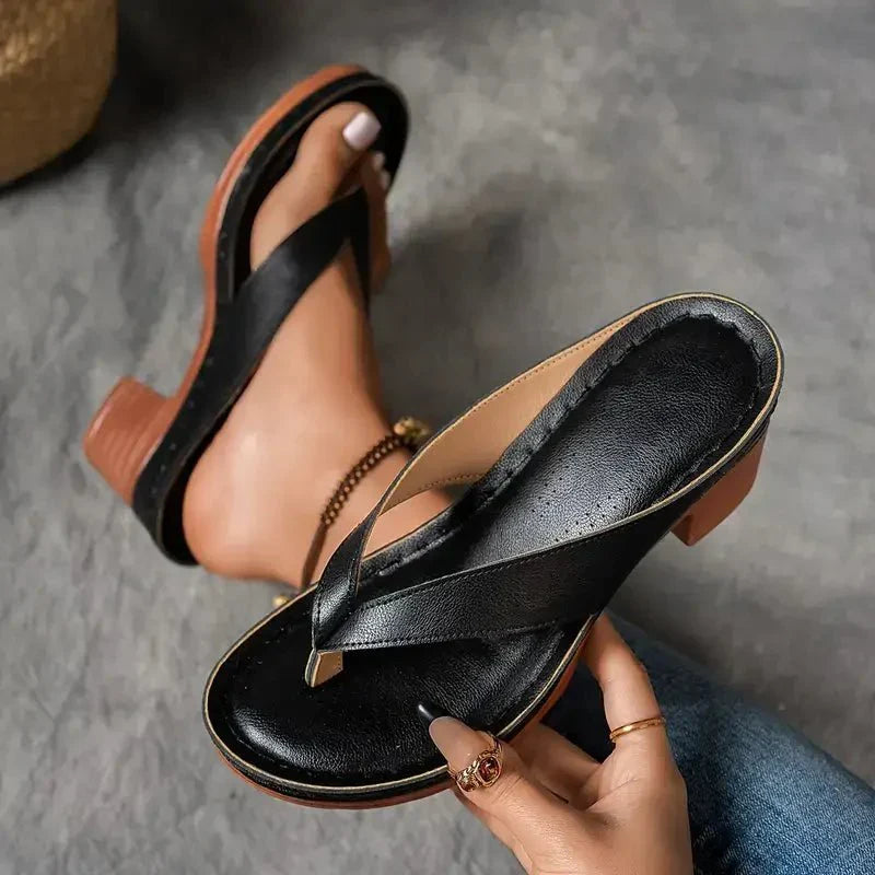 Slip-on black women's sandals designed for orthopedic comfort with a low heel.