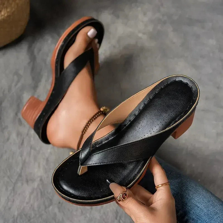 Slip-on black women's sandals designed for orthopedic comfort with a low heel.