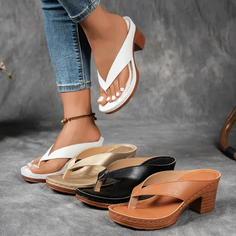 Elegant black women's orthopedic sandals, ensuring comfort with a low heel and arch support.