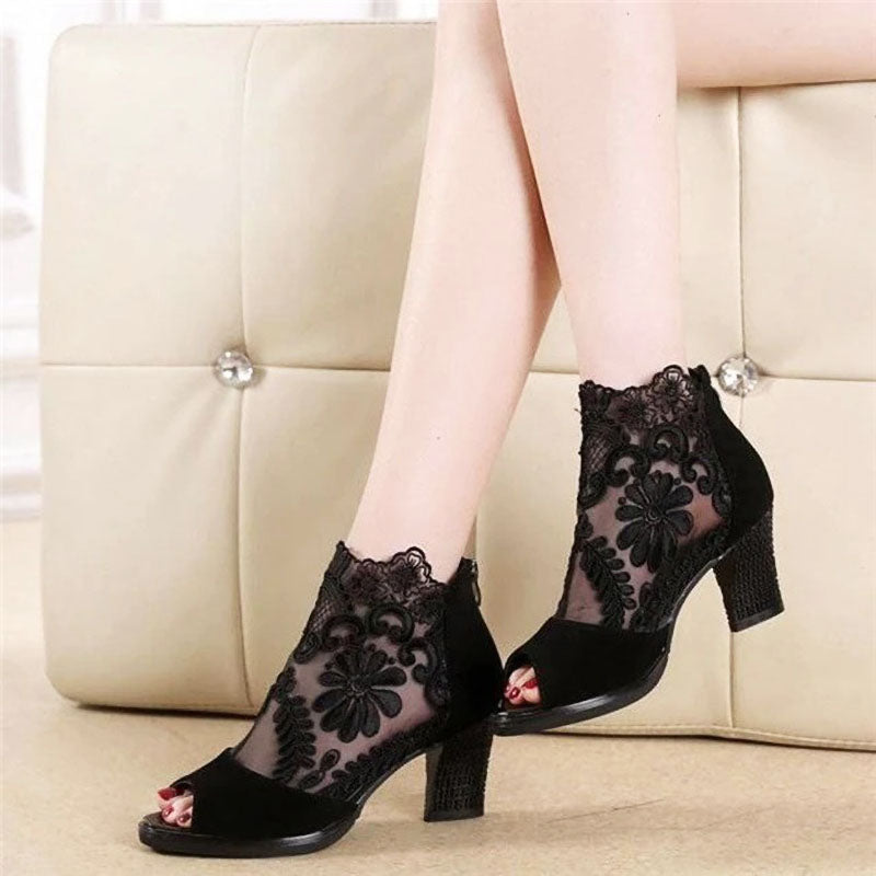 Elegant black high heels for women, featuring a peep toe, ankle strap, and beautiful floral design.