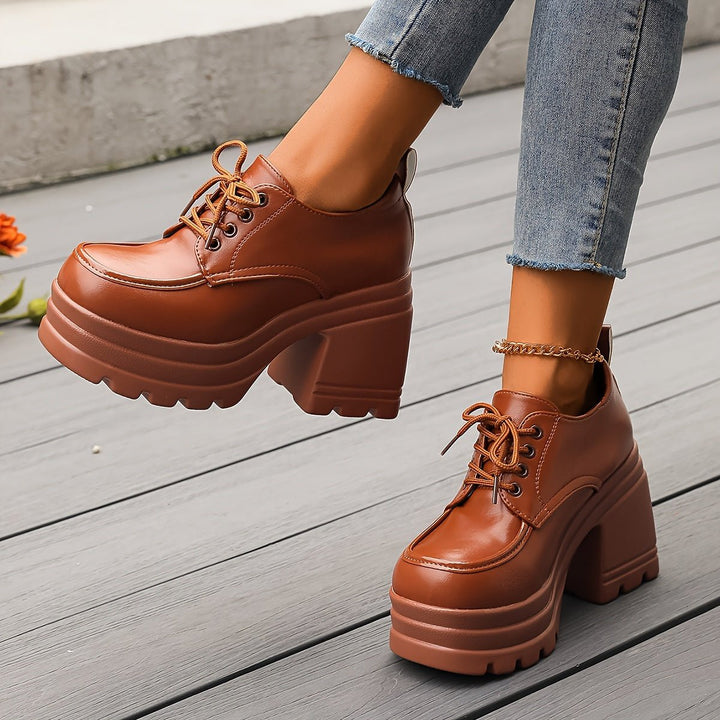 Retro black platform oxfords for women, featuring a comfortable chunky heel and lace-up design.