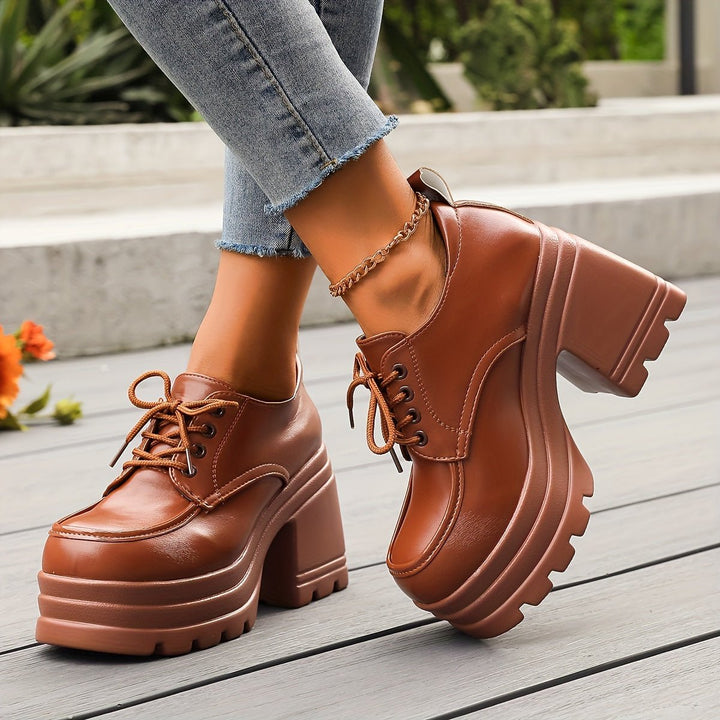 Designer quality women's footwear: black platform oxford shoes with a stylish chunky heel.