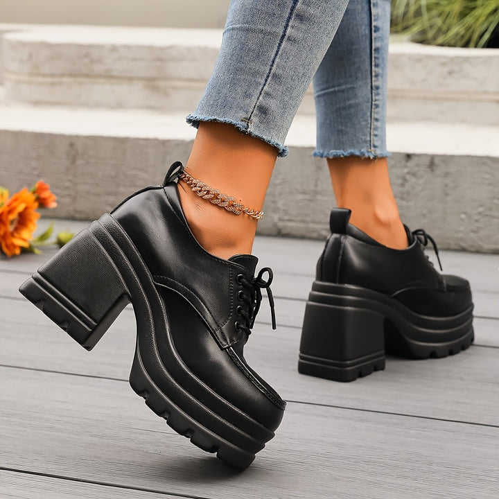 Fashionable black platform oxford shoes for women, chunky heel adds a retro touch.