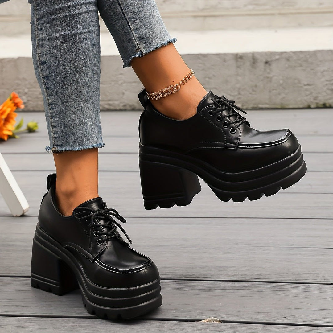 Comfortable black platform oxfords with a chunky heel, classic lace-up design for women.