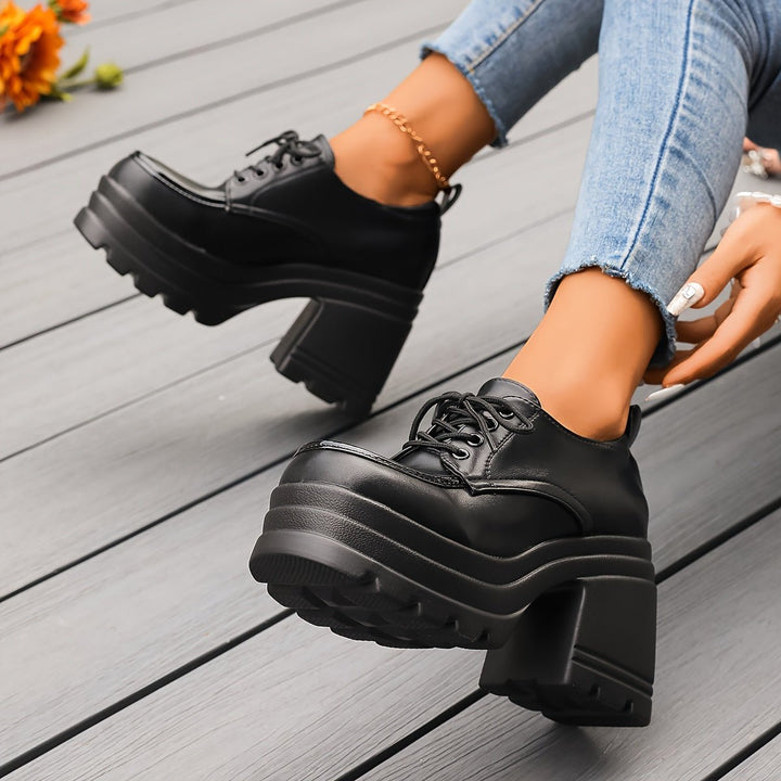 Retro-inspired women's black platform oxford shoes, chunky heel and lace-up details.