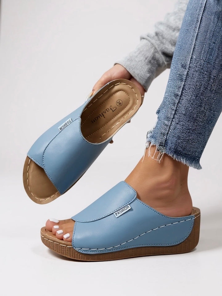 Sleek women's platform slip-on sandals, ideal for modern, casual outfits.