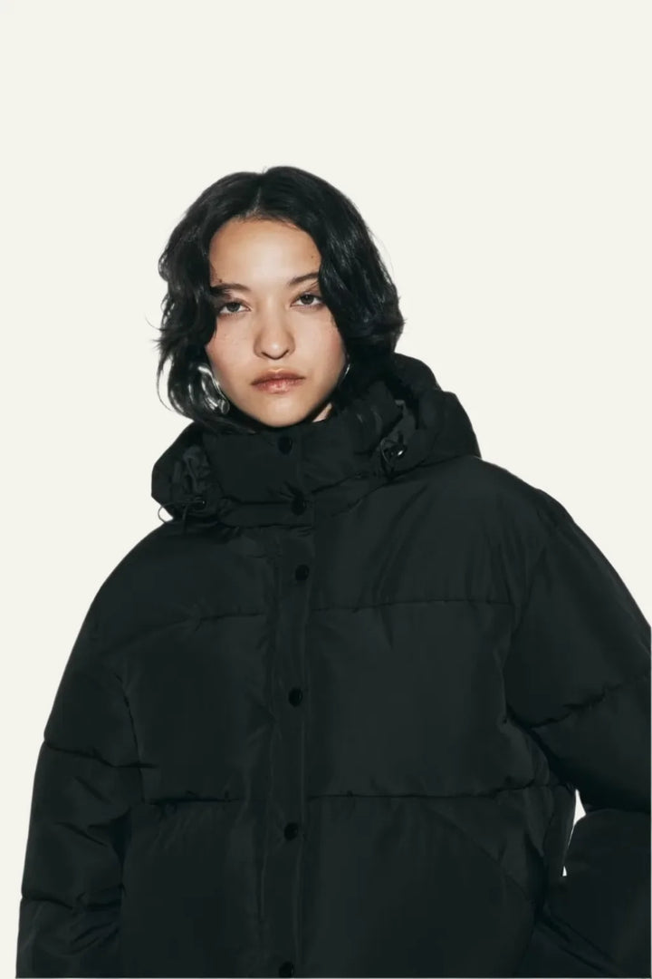 Lightweight women's black puffer jacket, ideal warm winter coat for everyday fashion. Insulated and comfortable.