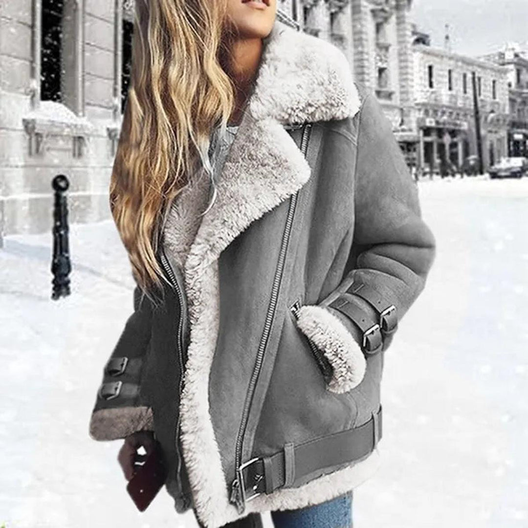 Warm grey women's belted winter jacket, designed with practical pockets. Stylish essential cold weather outerwear.