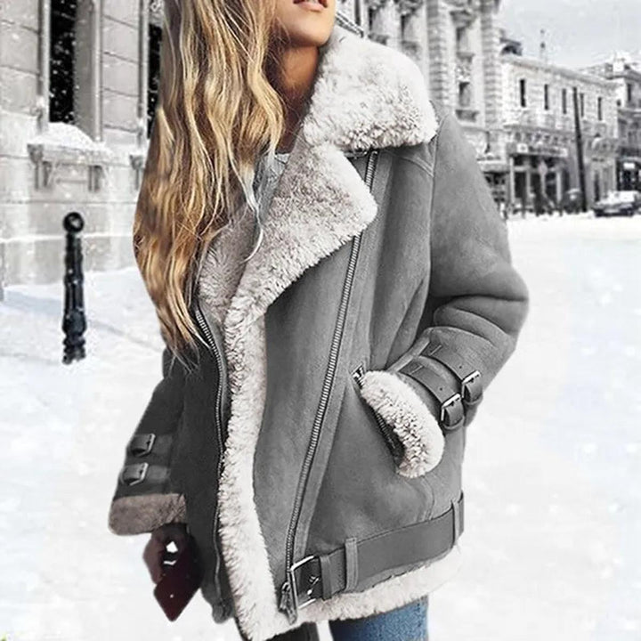 Warm grey women's belted winter jacket, designed with practical pockets. Stylish essential cold weather outerwear.