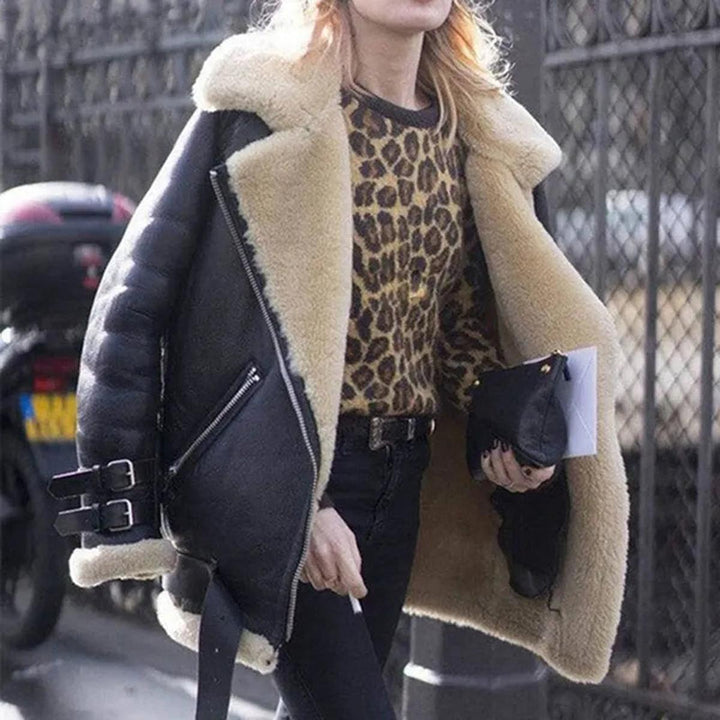 Stylish black women's winter coat, complete with a belt & useful pockets. Ideal for warmth & fashion.