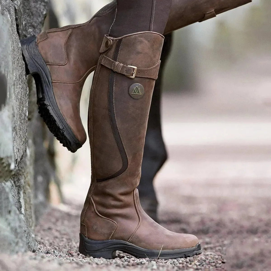 Women's black waterproof winter riding boots, tall & stylish for all-weather equestrian adventures.