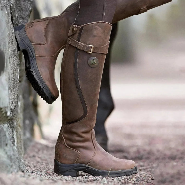 Women's black waterproof winter riding boots, tall & stylish for all-weather equestrian adventures.