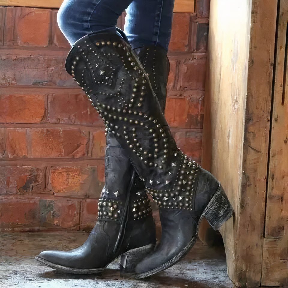 Stylish women's Western knee-high cowboy boots featuring silver stud embellishments.