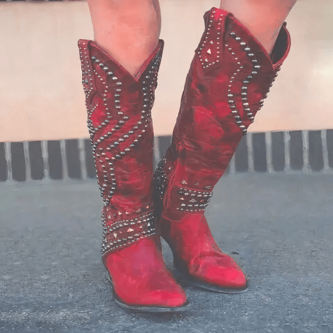 Knee-high studded Western boots for women, perfect for a fashionable look. Features a block heel.