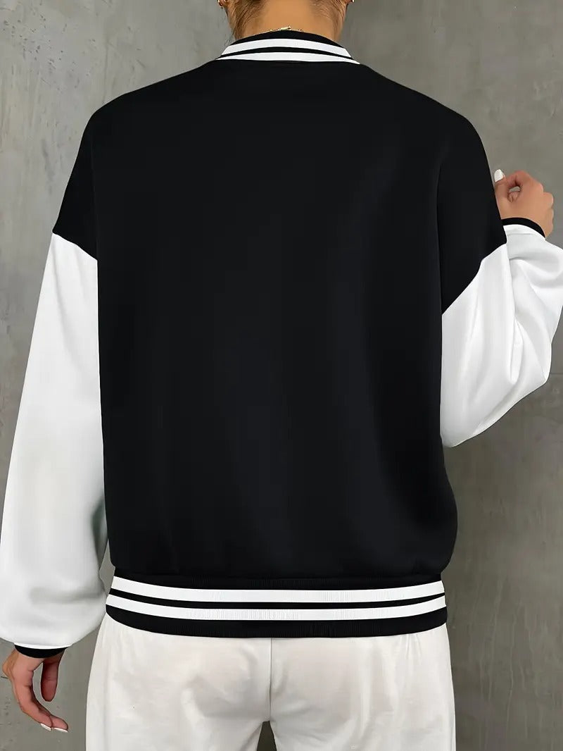 Sporty chic black & white women's bomber jacket. Features striped trim, snap buttons, ideal for casual spring/fall wear.