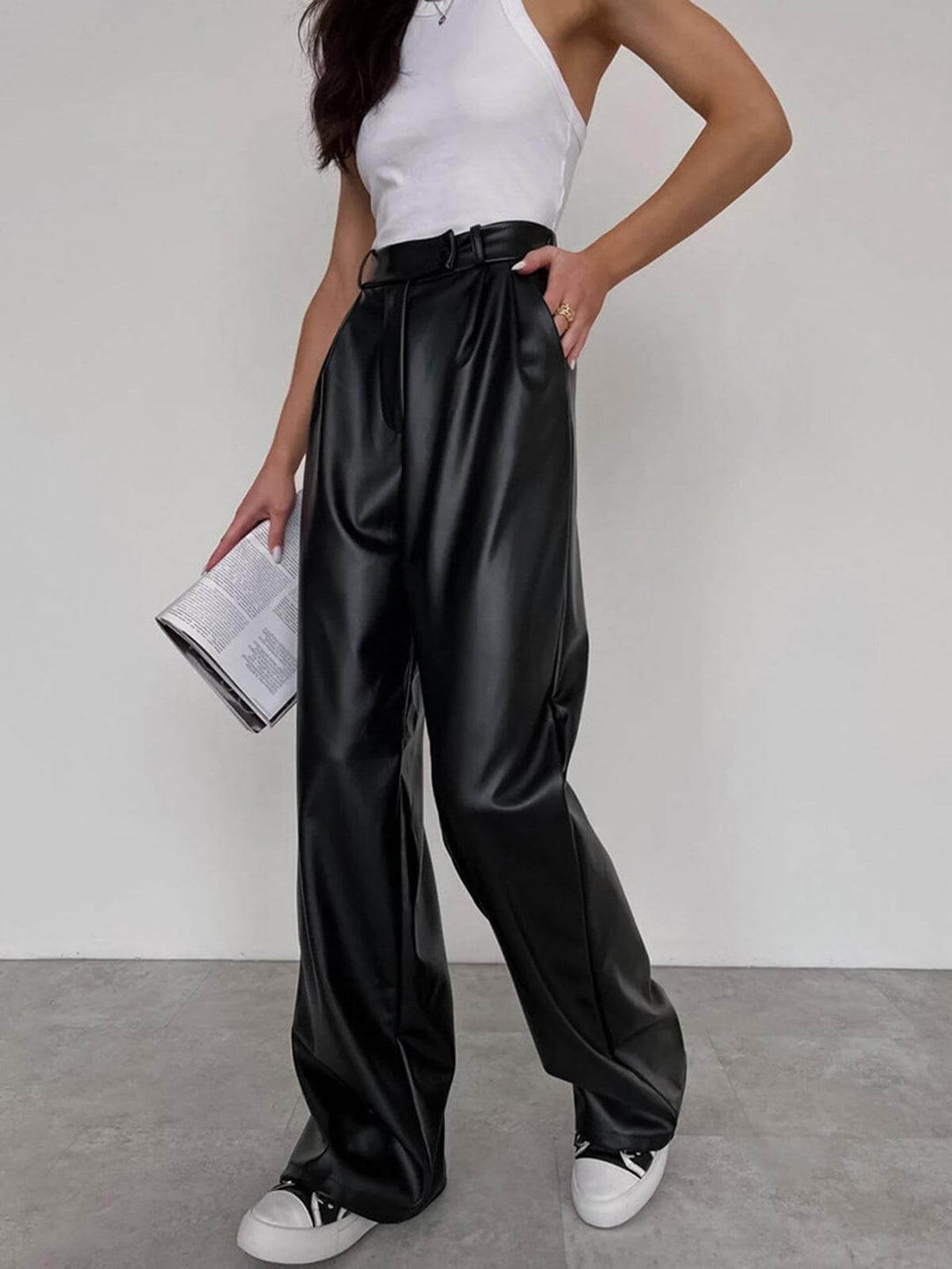 Stylish women's vegan leather wide-leg trousers. Chic black faux leather pants, perfect for fashion-forward day or evening looks.