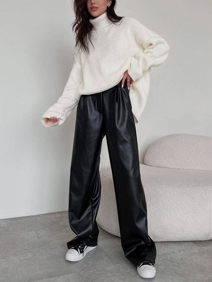 Comfortable women's wide-leg faux leather trousers. Versatile black pants suitable for chic day wear or elegant evening outfits.