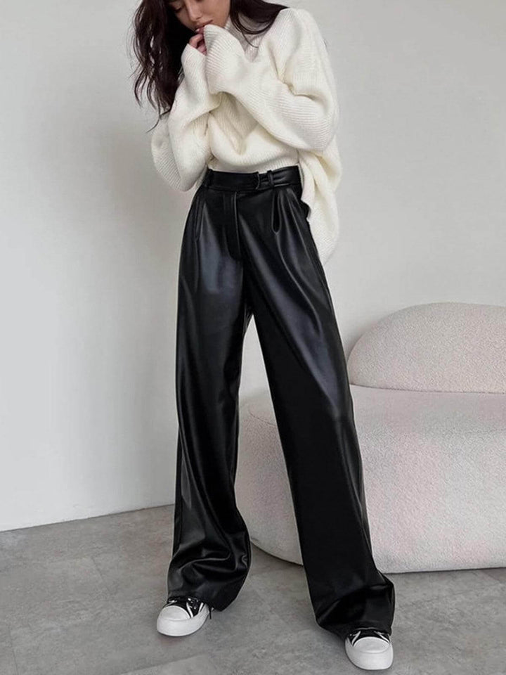 Chic women's wide-leg faux leather dress pants. Stylish black vegan leather trousers for a modern, fashion-forward look.