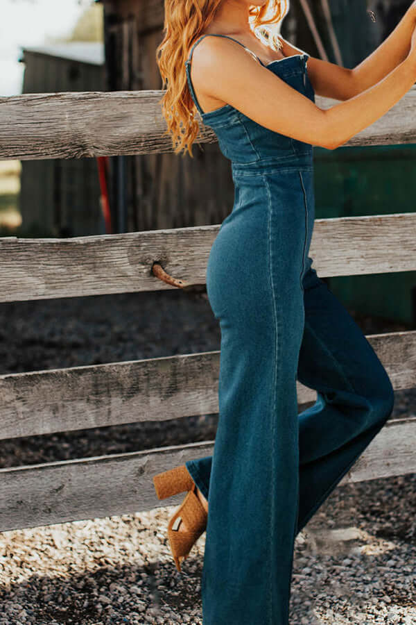 Front view of a women's blue denim sleeveless wide leg jumpsuit, showcasing its casual, versatile summer appeal.