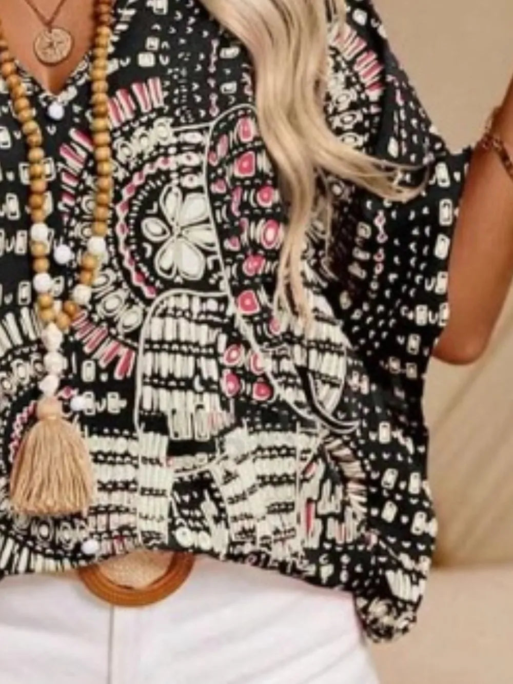 Casual boho printed V-neck blouse for women, vibrant summer print, flowy silhouette.