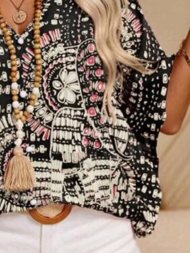 Casual boho printed V-neck blouse for women, vibrant summer print, flowy silhouette.