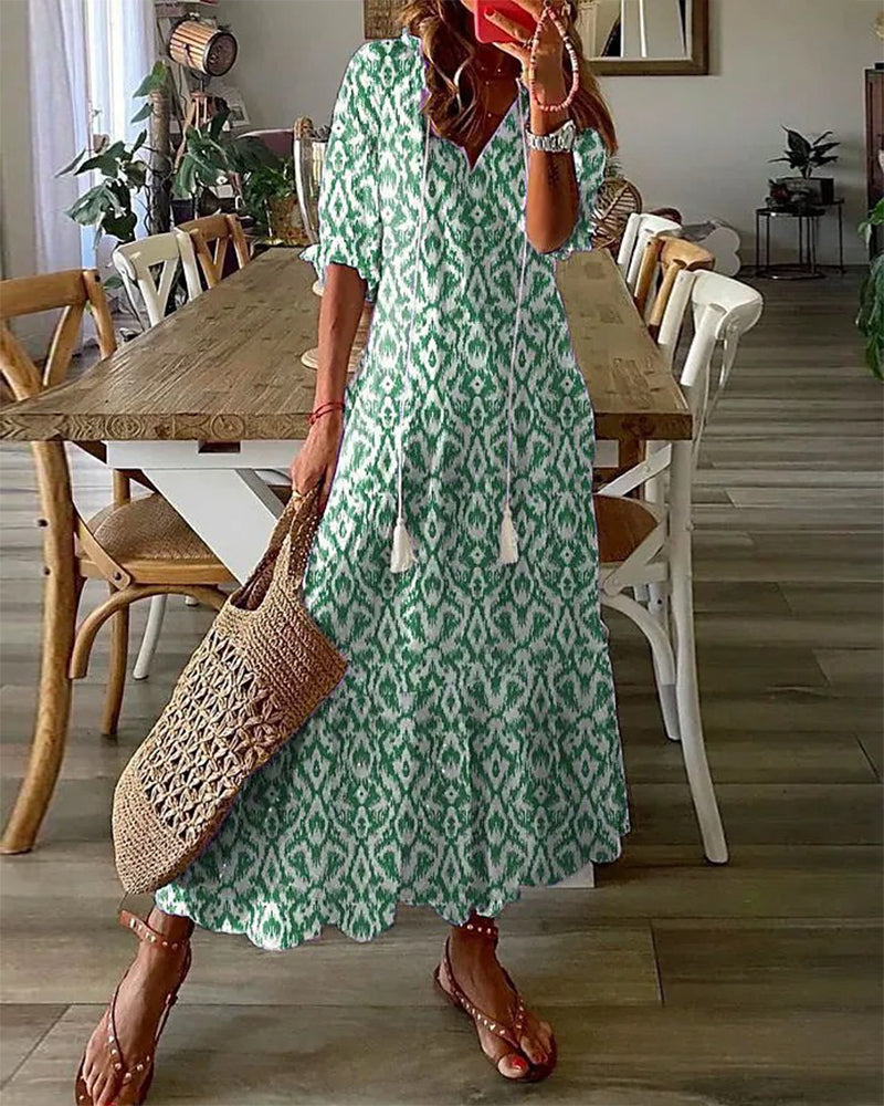 Flowy bohemian women's maxi dress. Comfortable V-neck design with a vibrant vintage print for spring/summer.