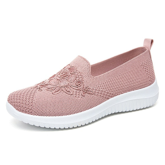 Embroidered slip-on sandals for women, breathable fabric, offering crucial arch support for daily wear.