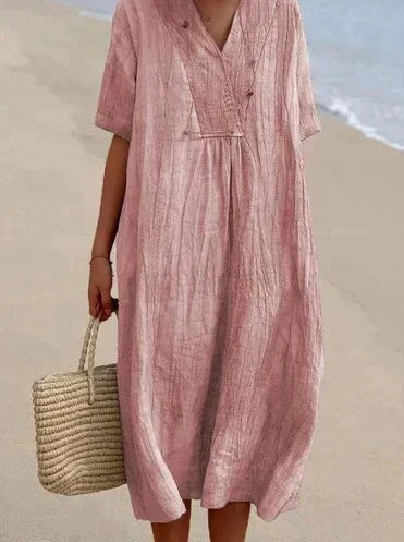 Detail shot: breezy cotton linen fabric of the Women's Aria summer dress, highlighting texture and V-neckline.