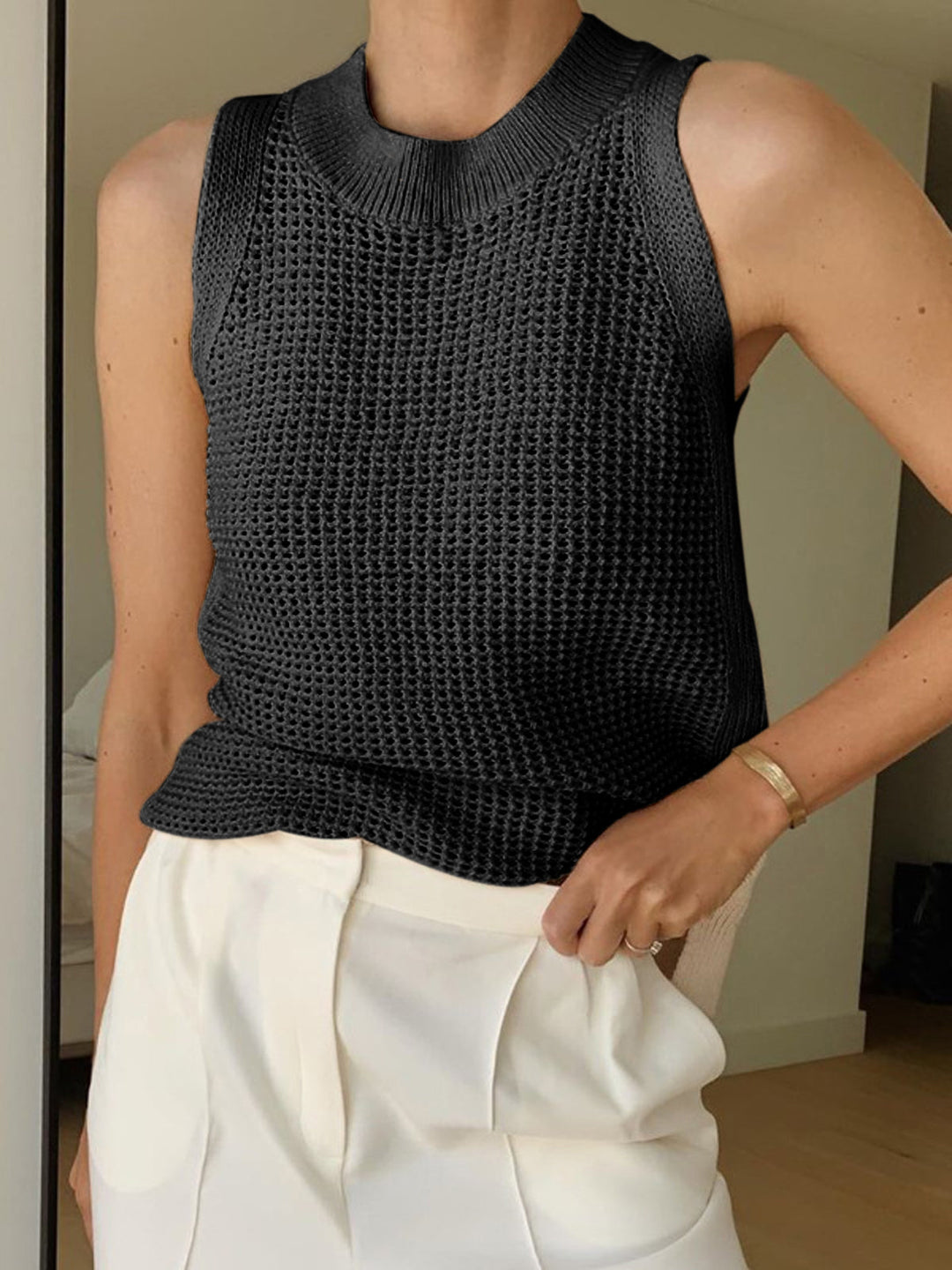 Versatile women's hollow knit tank top, breathable & lightweight. Ideal summer layering top or casual wear.