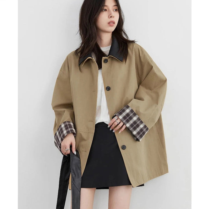 Fashionable women's button-up jacket, chic contrast trim, great for spring and fall outerwear.