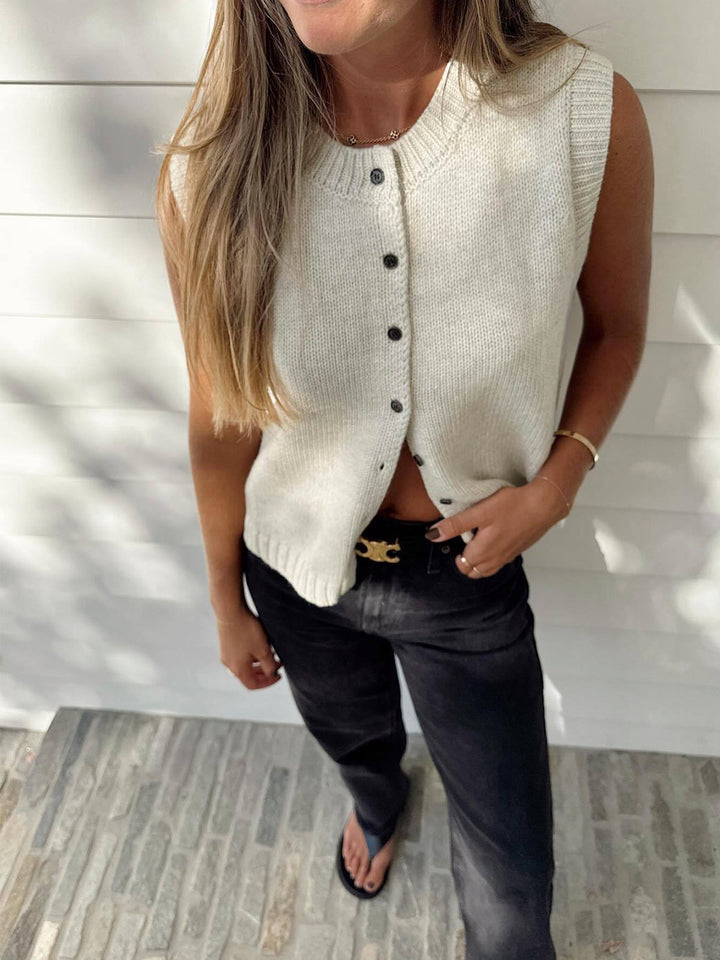 Light grey women's button-up sweater vest. Casual sleeveless top, ideal for spring & fall layering.