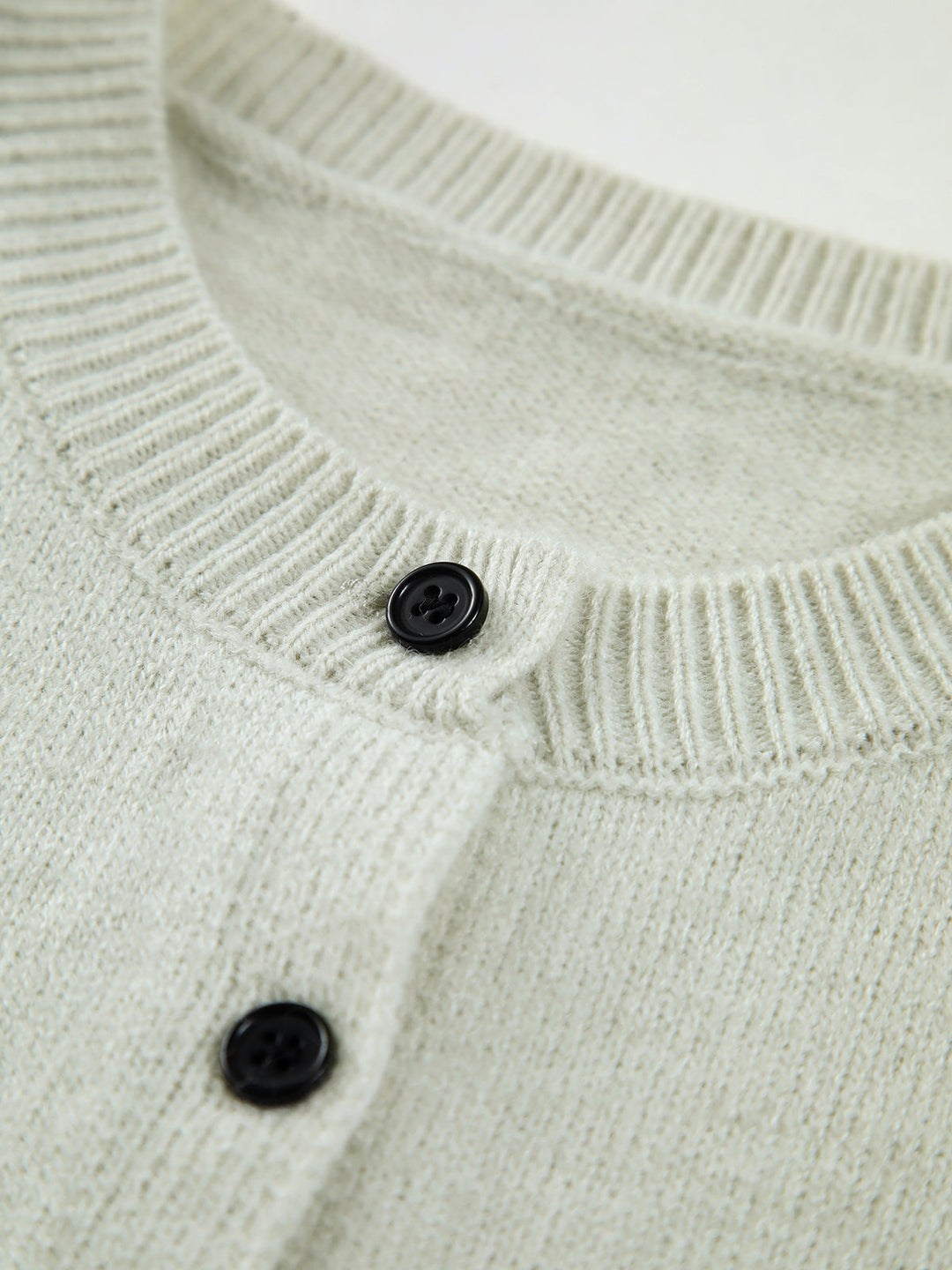 Versatile women's button-up sweater vest. Sleeveless, chic layering piece for spring and fall outfits.
