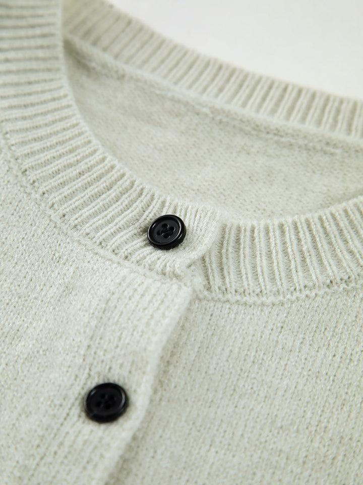 Versatile women's button-up sweater vest. Sleeveless, chic layering piece for spring and fall outfits.