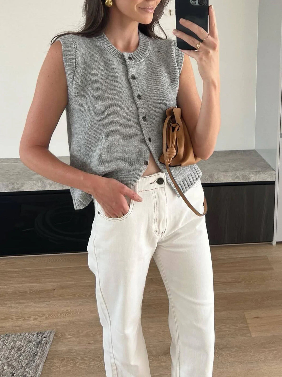 Women's versatile button-up sweater vest. Sleeveless, chic layering piece for fall, spring, casual outfits.