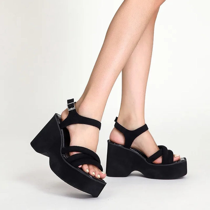 Fashionable Carmela black strappy sandals, essential women's footwear for sleek summer style.