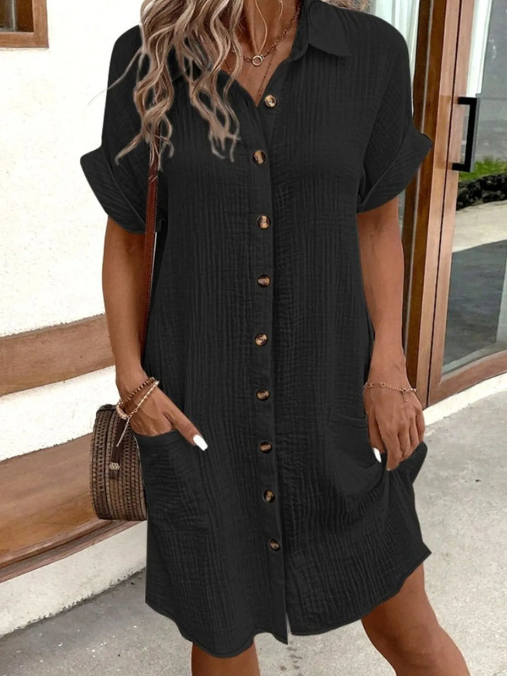Blue women's button-down mini shirt dress, short sleeve, pockets; a casual summer fashion essential.