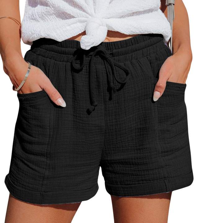 Close-up of women's relaxed fit casual shorts, showing functional front pockets & adjustable drawstring.