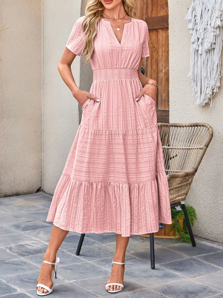 Women's casual flowy midi dress with short sleeves & convenient pockets, perfect for summer comfort.