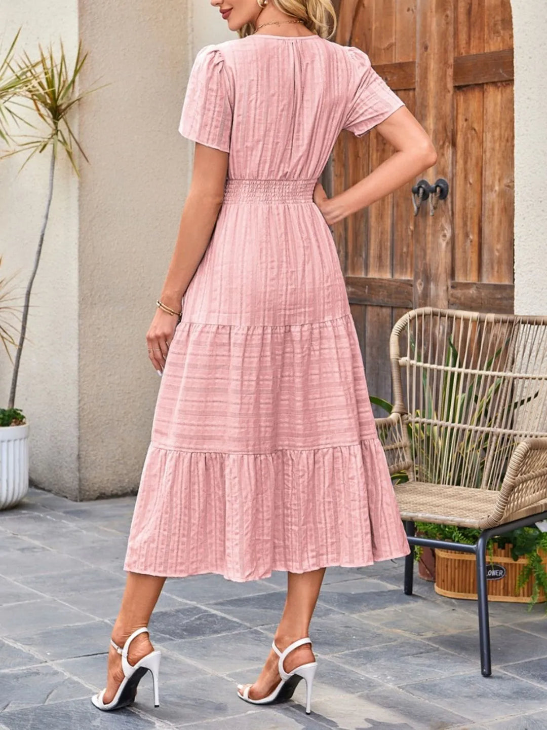 Stylish women's tiered midi dress, flowy and comfortable, featuring practical side pockets.