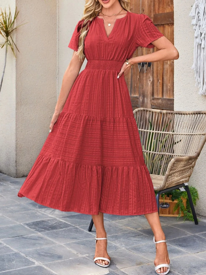 Women's short sleeve midi dress with a beautiful flowy drape and discreet, functional pockets.