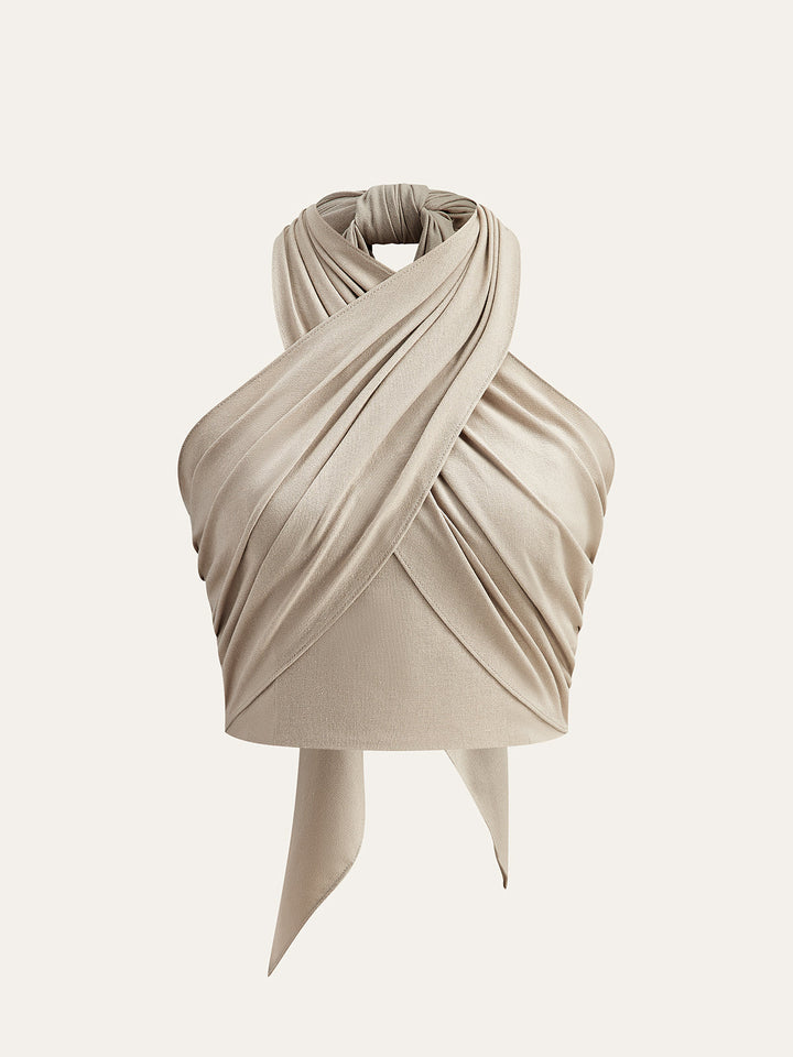 Stylish women's beige crisscross halter crop top. Versatile and trendy for summer outfits and casual looks.